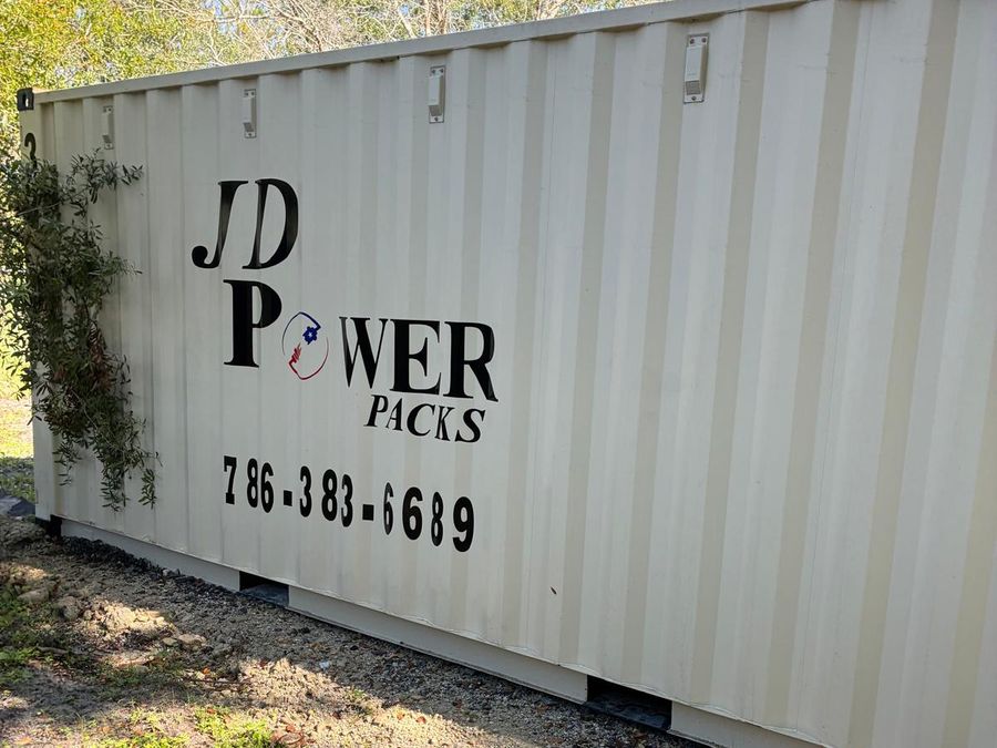 Side of a JD Power Packs container with the company logo and the
                  phone number 786-383-6689 painted on it.
